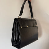 Black patent 1960s mod vintage handbag with abstract buckle detail