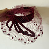 Dramatic 1950s burgundy velvet sculpted vintage halo cocktail hat with veil
