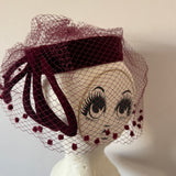 Dramatic 1950s burgundy velvet sculpted vintage halo cocktail hat with veil