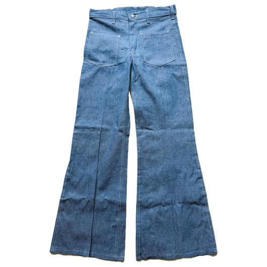 Pair of blue vintage flared jeans on a white background