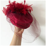Claret satin vintage pillbox hat with mesh veil and feather trim